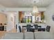Dining area and kitchen layout with barstool seating and elegant décor, next to hallway at 6611 Grand Estuary Trl # 105, Bradenton, FL 34212