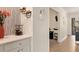 Hallway leading to a home office with wine rack at 6611 Grand Estuary Trl # 105, Bradenton, FL 34212