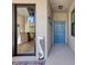 Hallway view with blue door and ceramic sculpture at 6611 Grand Estuary Trl # 105, Bradenton, FL 34212