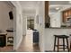 Hallway view leading to the kitchen and patio, accented with stylish furnishings and artwork at 6611 Grand Estuary Trl # 105, Bradenton, FL 34212