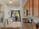 Open kitchen layout showcasing granite countertops, stainless steel appliances, and a view to the patio at 6611 Grand Estuary Trl # 105, Bradenton, FL 34212