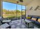 Relaxing screened lanai with comfortable seating and view of landscaped yard at 6611 Grand Estuary Trl # 105, Bradenton, FL 34212