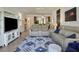 Cozy living room with modern furnishings, open to the dining area and featuring a stylish area rug at 6611 Grand Estuary Trl # 105, Bradenton, FL 34212