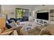 Welcoming living room with ceiling fan, comfortable recliner sofa, and a screened lanai at 6611 Grand Estuary Trl # 105, Bradenton, FL 34212