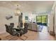 Open-concept living and dining area featuring patio access and comfortable seating at 6611 Grand Estuary Trl # 105, Bradenton, FL 34212