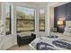 Comfortable bedroom featuring a stylish decor and a large window letting in plenty of natural light at 6611 Grand Estuary Trl # 105, Bradenton, FL 34212