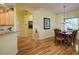 Elegant dining area with wood floors, chandelier, and views of the outdoors from the bay window at 6619 Copper Ridge Trl, Bradenton, FL 34201