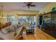 Inviting living room featuring a ceiling fan, hardwood floors, and comfortable seating at 6619 Copper Ridge Trl, Bradenton, FL 34201