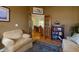 Inviting living room with hardwood floors, comfortable armchairs, and view to dining room at 6619 Copper Ridge Trl, Bradenton, FL 34201