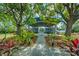 Outdoor recreation area with seating, lighting, and lush plantings, adjacent to walkway at 6619 Copper Ridge Trl, Bradenton, FL 34201