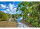 Waterfront landscape with dock access, serene lake view and lush vegetation under sunny skies at 6619 Copper Ridge Trl, Bradenton, FL 34201
