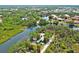 Expansive aerial view of a home nestled among lush greenery and waterways in a vibrant waterfront community at 6737 Lincoln Rd, Bradenton, FL 34203