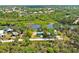 Aerial view of waterfront property, showcasing lush landscaping, canals, and peaceful neighborhood at 6737 Lincoln Rd, Bradenton, FL 34203