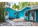 Backyard featuring a small palm tree and a bright blue house at 6737 Lincoln Rd, Bradenton, FL 34203