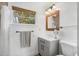 Bathroom featuring a stone tile shower, vanity, and a mirror at 6737 Lincoln Rd, Bradenton, FL 34203