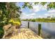 Wooden dock featuring a bench with waterfront views at 6737 Lincoln Rd, Bradenton, FL 34203