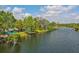 Waterfront home with vibrant blue exterior, wooden deck, and serene water views at 6737 Lincoln Rd, Bradenton, FL 34203