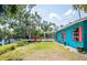 Colorful exterior with a well manicured lawn and mature trees at 6737 Lincoln Rd, Bradenton, FL 34203