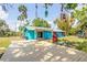 Brightly painted coastal home with an inviting patio, offering a relaxing outdoor space and vibrant curb appeal at 6737 Lincoln Rd, Bradenton, FL 34203