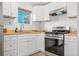 Galley kitchen featuring new countertops, cabinets, and stainless steel appliances at 6737 Lincoln Rd, Bradenton, FL 34203