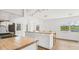 Bright kitchen with white cabinets, butcher block island, and views of the lake at 6737 Lincoln Rd, Bradenton, FL 34203
