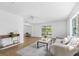 Open living room with bright interior, modern ceiling fan, and views of the backyard at 6737 Lincoln Rd, Bradenton, FL 34203