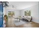 Bright living room features wood floors, modern furniture, and views of the outdoors at 6737 Lincoln Rd, Bradenton, FL 34203