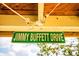 Humorous view of a 'Jimmy Buffett Drive' sign hanging outdoors, adding character and local charm at 6737 Lincoln Rd, Bradenton, FL 34203