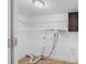 Utility room featuring open shelving, laminate floors, and a laundry hookup at 6737 Lincoln Rd, Bradenton, FL 34203
