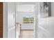 Hallway view to kitchen, showcasing views of a body of water and nature at 6737 Lincoln Rd, Bradenton, FL 34203