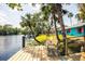 Relax on the waterfront deck with views of the property, palm trees, and serene river at 6737 Lincoln Rd, Bradenton, FL 34203