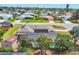 Overhead view showcasing the property, pool with screen enclosure, lush landscaping, and solar panels at 6820 19Th W Ave, Bradenton, FL 34209