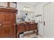 Bathroom showcasing an ornate wood vanity, vessel sink, and neutral tile flooring at 6820 19Th W Ave, Bradenton, FL 34209