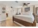 A cozy bedroom featuring a wood-framed bed, wood floors, and view into a bathroom area at 6820 19Th W Ave, Bradenton, FL 34209