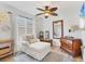 Cozy bedroom showcasing wood floors, ceiling fan, and lots of natural light at 6820 19Th W Ave, Bradenton, FL 34209