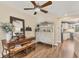 Dining room with hutch, wood floors and ceiling fan with seating area near modern kitchen at 6820 19Th W Ave, Bradenton, FL 34209