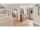 Inviting foyer featuring hardwood floors, decorative mirror, and entry to kitchen and living areas at 6820 19Th W Ave, Bradenton, FL 34209