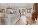 Open concept living area leading to dining and kitchen with neutral paint and light wood flooring at 6820 19Th W Ave, Bradenton, FL 34209