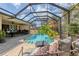 Stunning pool with screen enclosure, brick pavers, surrounded by lush greenery and a cozy seating area at 6820 19Th W Ave, Bradenton, FL 34209