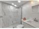 Modern bathroom featuring a glass-enclosed shower with marble-like tile and updated fixtures at 6946 Woodwind Dr # 2, Sarasota, FL 34231