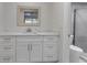 Modern bathroom featuring a white vanity, marble countertop, and glass-enclosed shower at 6946 Woodwind Dr # 2, Sarasota, FL 34231