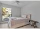 Comfortable bedroom with a large window providing natural light, creating a relaxing space at 6946 Woodwind Dr # 2, Sarasota, FL 34231