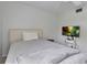 Serene bedroom with a bed, TV, and simple decor, offering a calming retreat at 6946 Woodwind Dr # 2, Sarasota, FL 34231