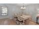 Formal dining room featuring a chandelier, window and tile flooring at 6946 Woodwind Dr # 2, Sarasota, FL 34231