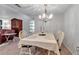 Dining room featuring a chandelier, table for four and view to the living room at 6946 Woodwind Dr # 2, Sarasota, FL 34231
