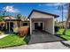 Single-story home with a covered parking area, landscaped front yard and blue sky at 6946 Woodwind Dr # 2, Sarasota, FL 34231