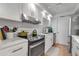 Bright kitchen featuring white cabinets, stainless steel appliances, and marble countertops at 6946 Woodwind Dr # 2, Sarasota, FL 34231