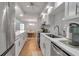 Open kitchen showcasing dining area with stainless steel appliances, countertops, and sink at 6946 Woodwind Dr # 2, Sarasota, FL 34231