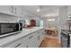 Updated kitchen with white marble countertop and stainless steel appliances in an open floor plan at 6946 Woodwind Dr # 2, Sarasota, FL 34231