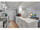 Updated kitchen with white cabinets, stainless steel appliances and a breakfast bar at 6946 Woodwind Dr # 2, Sarasota, FL 34231